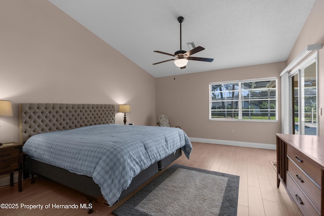 bedroom featuring light wood-type flooring, lofted ceiling, baseboards, ceiling fan, and access to outside