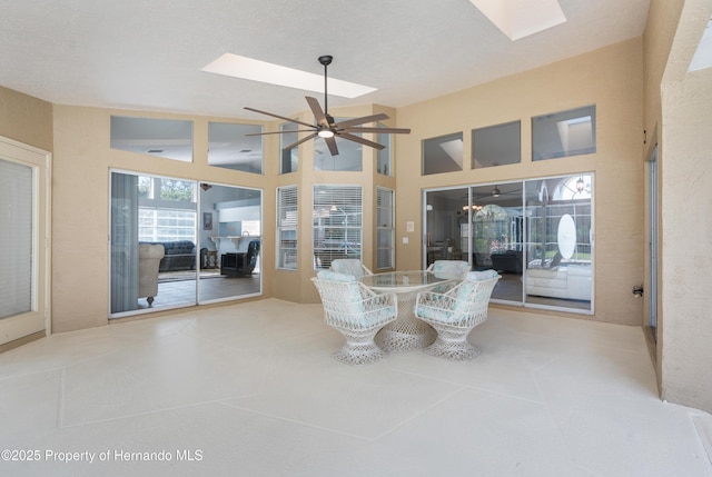 sunroom / solarium with a skylight and lofted ceiling