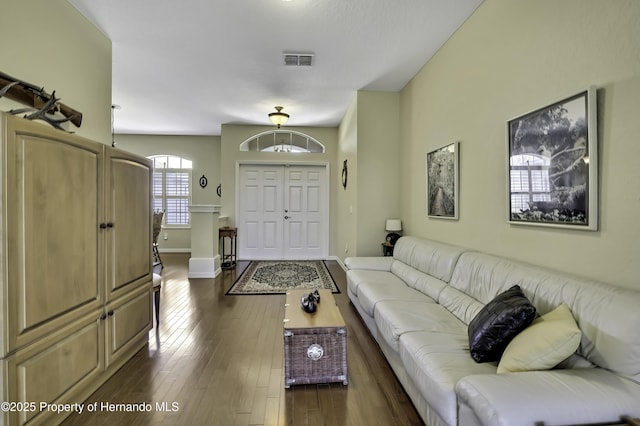 living room with dark wood-style flooring and baseboards