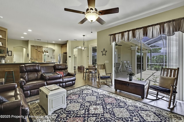 tiled living area featuring ceiling fan, recessed lighting, and a sink