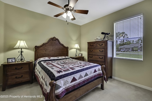 bedroom featuring light carpet, baseboards, and ceiling fan