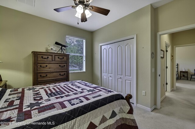 bedroom featuring carpet, a closet, ceiling fan, and baseboards