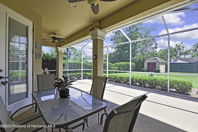 sunroom featuring a ceiling fan and plenty of natural light