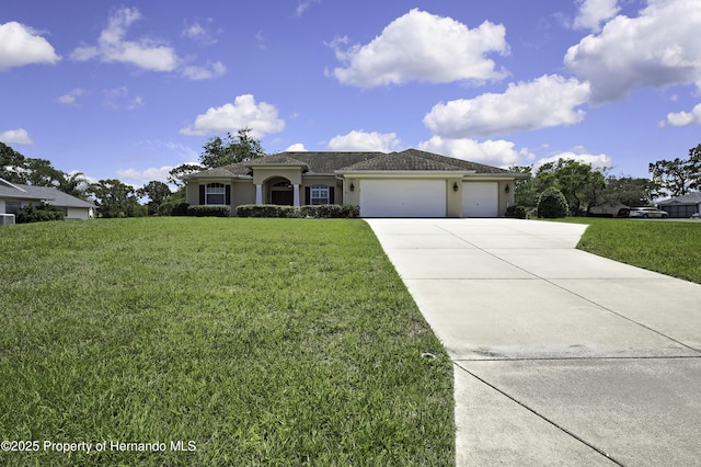 single story home with driveway, a garage, a front yard, and stucco siding