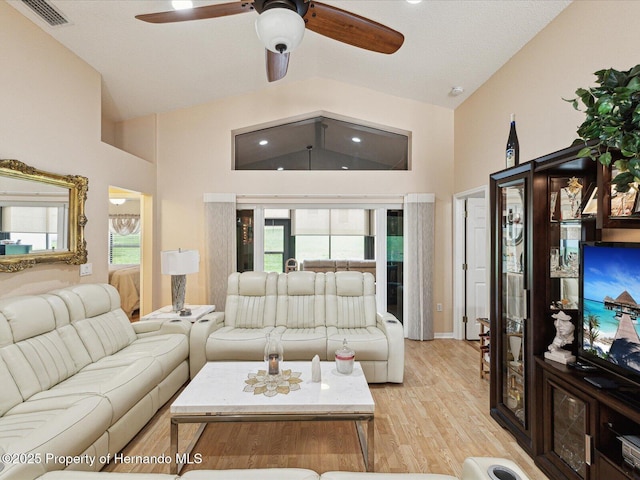 11350 Copley Ct, Spring Hill, FL 34609 - living room with ceiling fan, light wood finished floors, and high vaulted ceiling