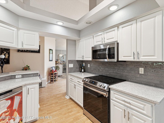 11350 Copley Ct, Spring Hill, FL 34609 - kitchen with stainless steel appliances, light wood-type flooring, white cabinetry, and recessed lighting