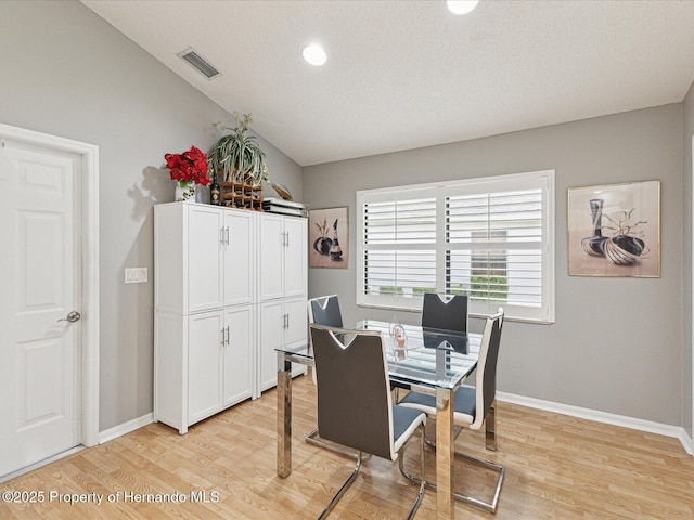11350 Copley Ct, Spring Hill, FL 34609 - dining space featuring light wood-style floors, baseboards, recessed lighting, and lofted ceiling