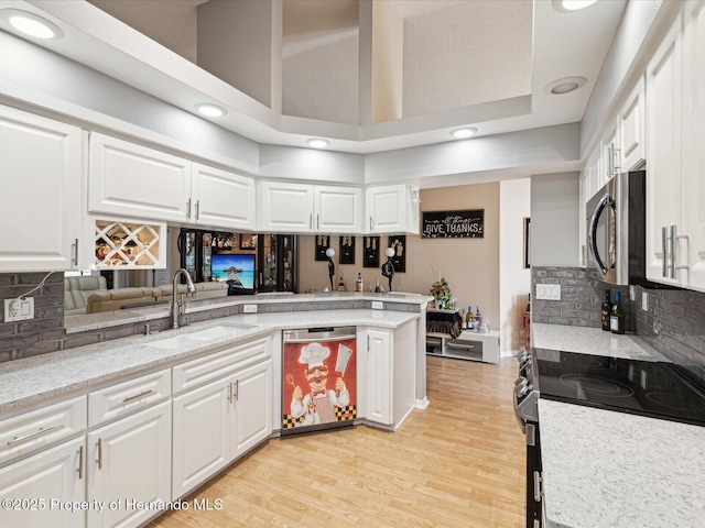 11350 Copley Ct, Spring Hill, FL 34609 - kitchen with stainless steel appliances, a sink, white cabinetry, light wood finished floors, and recessed lighting