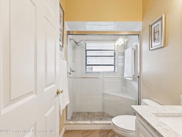 11350 Copley Ct, Spring Hill, FL 34609 - bathroom with a shower stall, toilet, vanity, and a textured wall