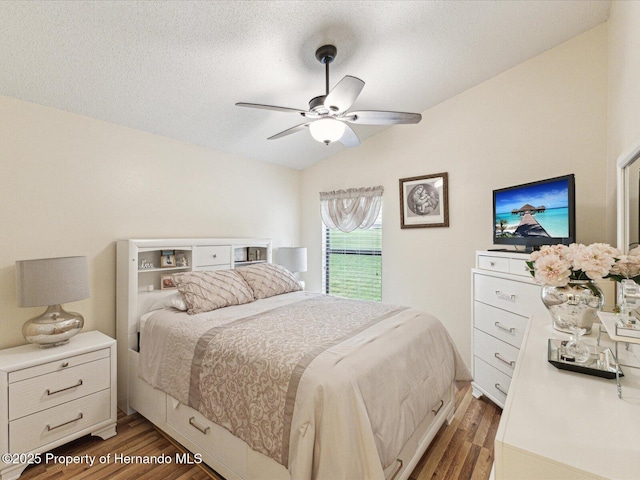 11350 Copley Ct, Spring Hill, FL 34609 - bedroom with wood finished floors, vaulted ceiling, a textured ceiling, and ceiling fan