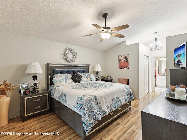11350 Copley Ct, Spring Hill, FL 34609 - bedroom featuring lofted ceiling, light wood finished floors, a chandelier, a textured ceiling, and ensuite bath