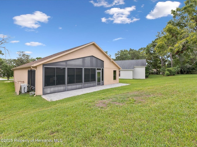 11350 Copley Ct, Spring Hill, FL 34609 - rear view of house with a patio, a yard, stucco siding, and a sunroom