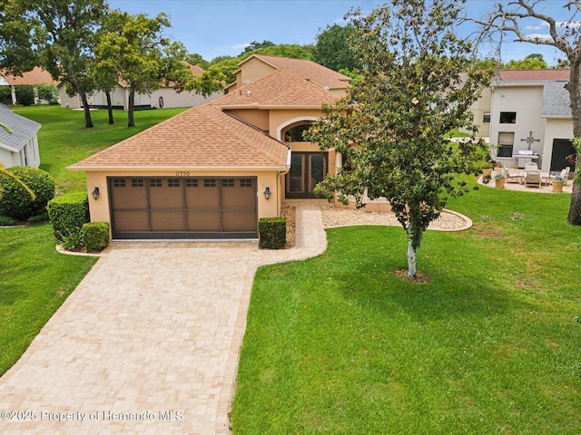 11350 Copley Ct, Spring Hill, FL 34609 - view of front of home featuring stucco siding, decorative driveway, an attached garage, a front lawn, and a shingled roof