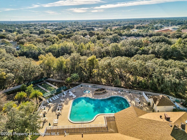 11350 Copley Ct, Spring Hill, FL 34609 - community pool featuring a patio, a view of trees, and fence
