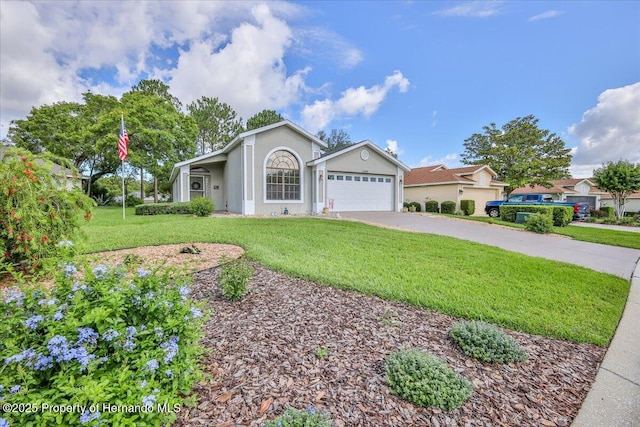 ranch-style home featuring driveway, a garage, a front yard, and stucco siding