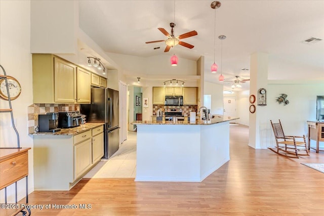 kitchen with a ceiling fan, black microwave, electric range, vaulted ceiling, and decorative backsplash