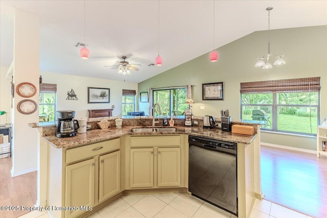 kitchen featuring black dishwasher, a sink, lofted ceiling, cream cabinetry, and a chandelier