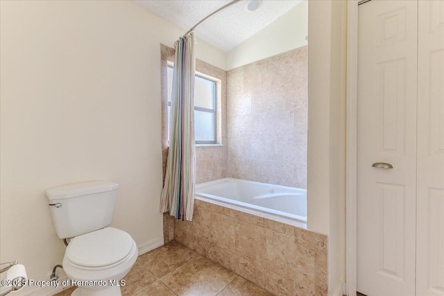 bathroom with tile patterned floors, toilet, a textured ceiling, and baseboards
