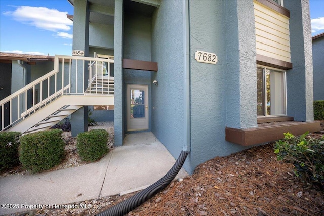 doorway to property with stucco siding