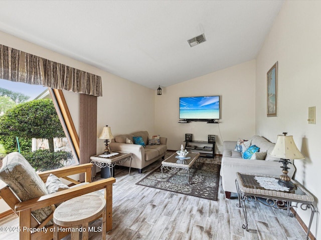 8393 Delaware Dr, Weeki Wachee, FL 34607 - living area with lofted ceiling and wood finished floors
