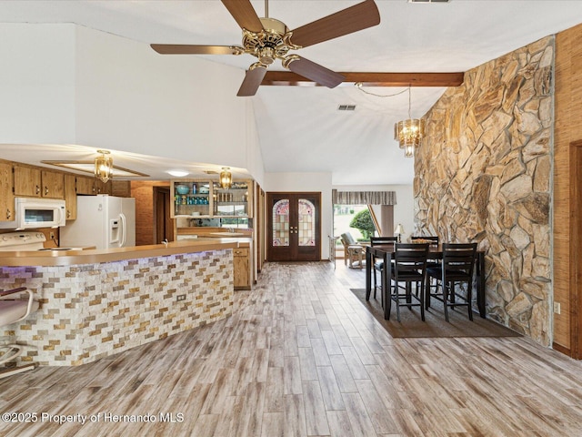 8393 Delaware Dr, Weeki Wachee, FL 34607 - living area featuring high vaulted ceiling, french doors, a chandelier, light wood-type flooring, and beamed ceiling