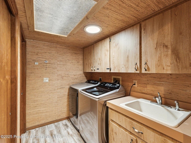 8393 Delaware Dr, Weeki Wachee, FL 34607 - washroom featuring cabinet space, washing machine and clothes dryer, wooden ceiling, and light wood finished floors