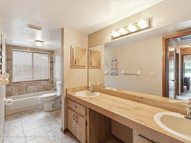 8393 Delaware Dr, Weeki Wachee, FL 34607 - bathroom featuring a textured ceiling, toilet, double vanity, washtub / shower combination, and tile patterned floors