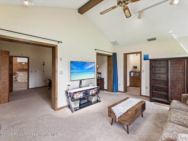 8393 Delaware Dr, Weeki Wachee, FL 34607 - living room featuring carpet, baseboards, a ceiling fan, beamed ceiling, and high vaulted ceiling