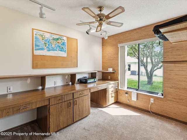 8393 Delaware Dr, Weeki Wachee, FL 34607 - unfurnished office with track lighting, built in study area, light colored carpet, ceiling fan, and a textured ceiling