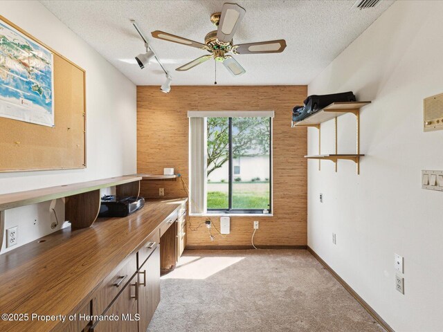 8393 Delaware Dr, Weeki Wachee, FL 34607 - unfurnished office featuring track lighting, a textured ceiling, ceiling fan, light carpet, and wood walls