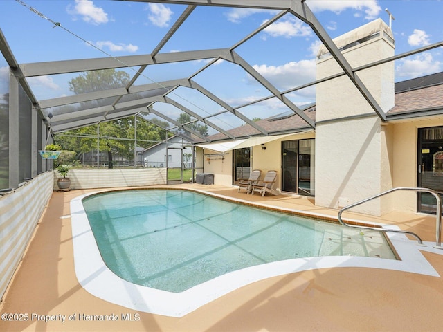 8393 Delaware Dr, Weeki Wachee, FL 34607 - outdoor pool featuring a patio area and glass enclosure