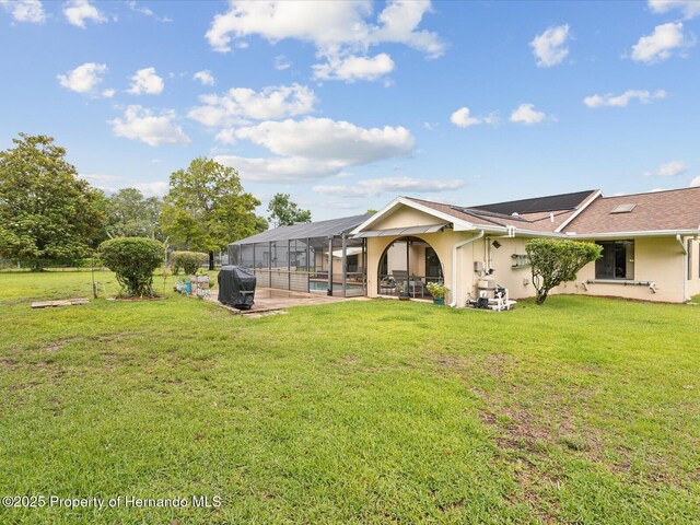 8393 Delaware Dr, Weeki Wachee, FL 34607 - back of house featuring stucco siding, a patio, a pool, and a yard