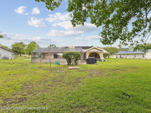 8393 Delaware Dr, Weeki Wachee, FL 34607 - back of house with a lawn and glass enclosure