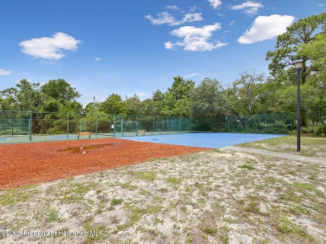 8393 Delaware Dr, Weeki Wachee, FL 34607 - view of property's community featuring a tennis court, community basketball court, and fence