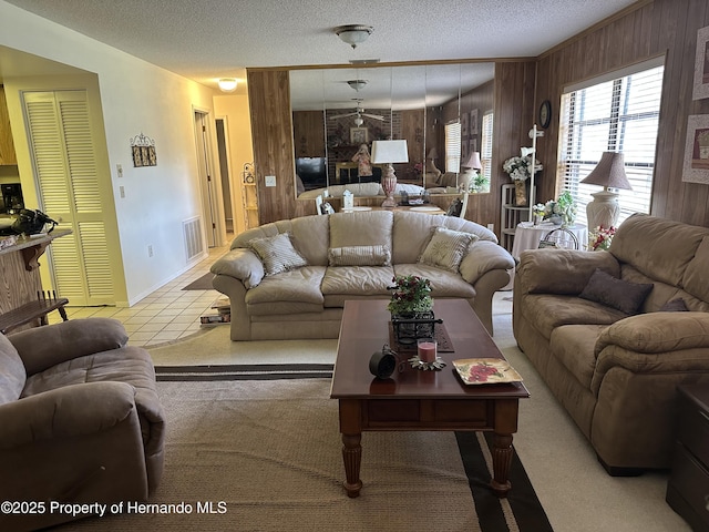 2351 Palm Springs Ct, Spring Hill, FL 34606 - tiled living room with wooden walls, a textured ceiling, and baseboards