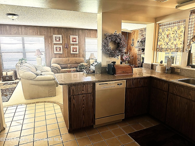 2351 Palm Springs Ct, Spring Hill, FL 34606 - kitchen featuring dishwasher, tile patterned flooring, dark brown cabinets, open floor plan, and a peninsula