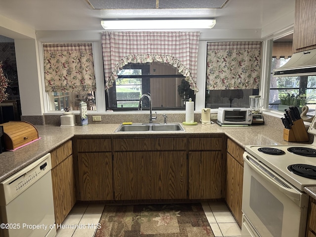 2351 Palm Springs Ct, Spring Hill, FL 34606 - kitchen featuring white appliances, a sink, light tile patterned floors, and plenty of natural light