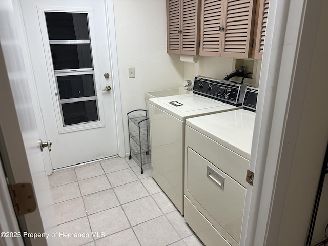 2351 Palm Springs Ct, Spring Hill, FL 34606 - laundry room featuring cabinet space, independent washer and dryer, and light tile patterned floors
