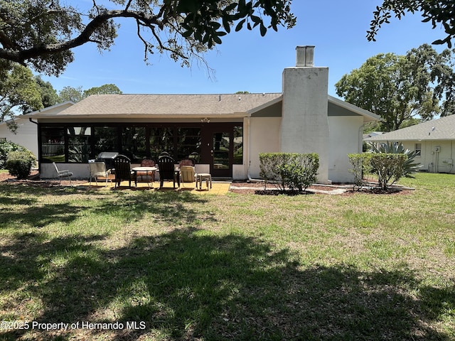 2351 Palm Springs Ct, Spring Hill, FL 34606 - back of house featuring a chimney, a yard, and stucco siding