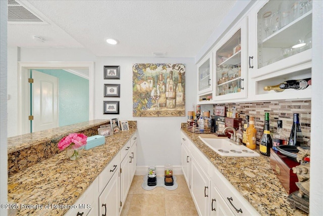 21000 Exeter Ct, Brooksville, FL 34601 - indoor wet bar with decorative backsplash, a textured ceiling, baseboards, light tile patterned floors, and recessed lighting