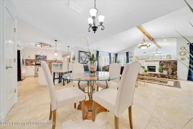 21000 Exeter Ct, Brooksville, FL 34601 - dining area featuring a chandelier, light tile patterned floors, and a glass covered fireplace
