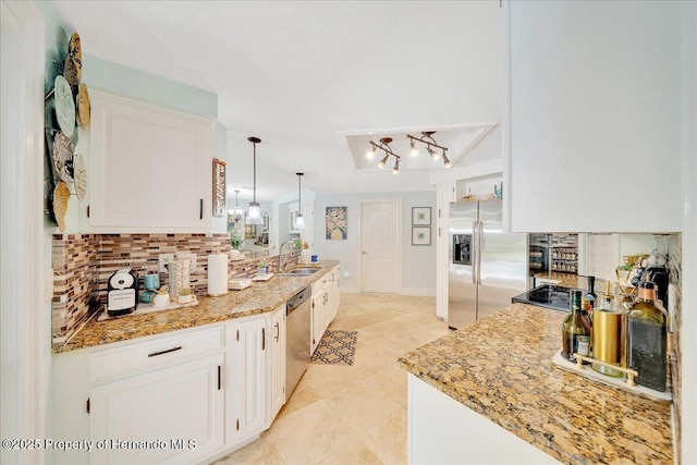 21000 Exeter Ct, Brooksville, FL 34601 - kitchen featuring appliances with stainless steel finishes, decorative backsplash, white cabinetry, and a sink