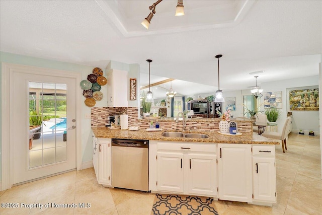 21000 Exeter Ct, Brooksville, FL 34601 - kitchen featuring stainless steel dishwasher, a sink, backsplash, and light stone counters