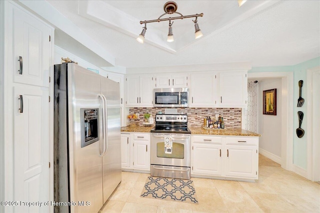 21000 Exeter Ct, Brooksville, FL 34601 - kitchen featuring stainless steel appliances, tasteful backsplash, light stone counters, and white cabinetry