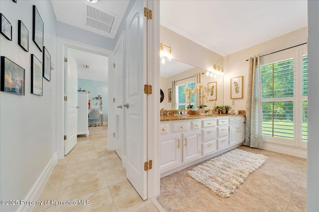 21000 Exeter Ct, Brooksville, FL 34601 - bathroom featuring double vanity, plenty of natural light, tile patterned flooring, and baseboards