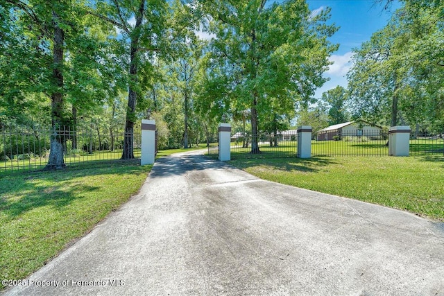 21000 Exeter Ct, Brooksville, FL 34601 - view of concrete driveway featuring a gated entry