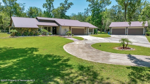 21000 Exeter Ct, Brooksville, FL 34601 - view of front of property featuring driveway, metal roof, a front yard, stone siding, and an attached garage