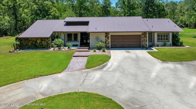 21000 Exeter Ct, Brooksville, FL 34601 - view of front of property featuring driveway, metal roof, a front yard, a garage, and stone siding