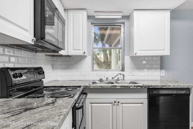 kitchen with black appliances, a sink, white cabinets, and tasteful backsplash