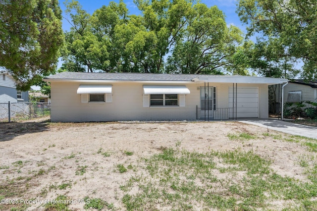 ranch-style house with fence, concrete driveway, and a garage